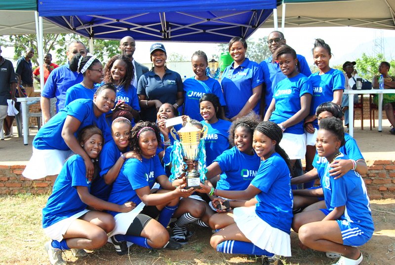 Genetrix Women’s Hockey Team show off their trophy after winning the 2014 Women’s Hockey League’s tournament